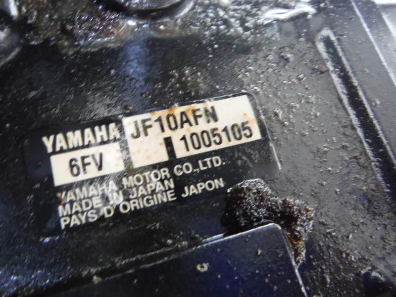 Slide: The Image of Close-up of Yamaha AR210 engine label, showing model and manufacturing details. - 13