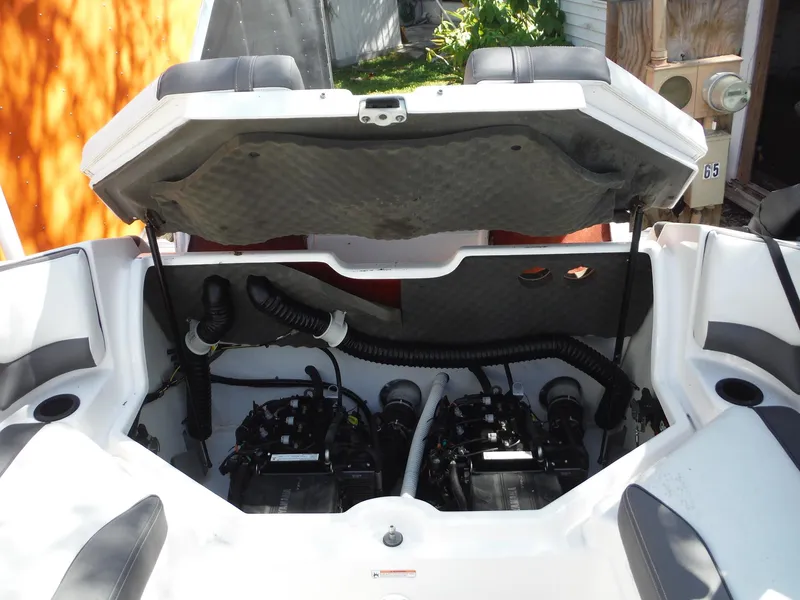 Slide: The Image of 2020 Yamaha AR210 boat engine compartment with open hatch, showcasing dual engines and interior components. - 18