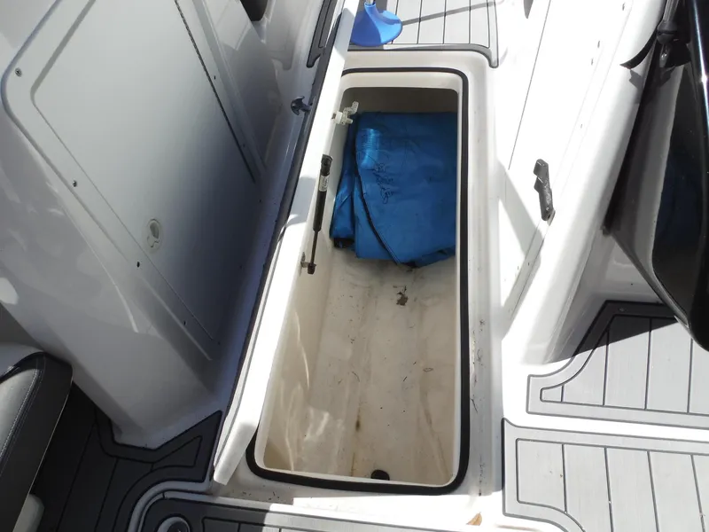 Slide: The Image of Storage compartment on 2020 Yamaha AR210 boat with blue cover inside. - 23