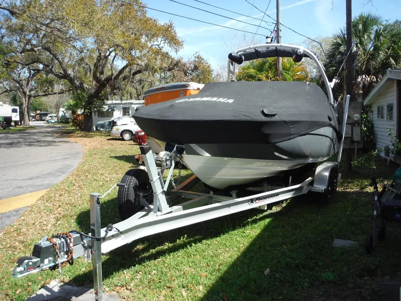 Slide: The Image of 2020 Yamaha AR210 boat on trailer, covered, parked in residential area. - 38