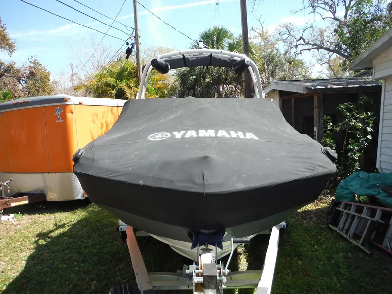 Slide: The Image of 2020 Yamaha AR210 boat covered, parked on trailer in residential yard. - 40
