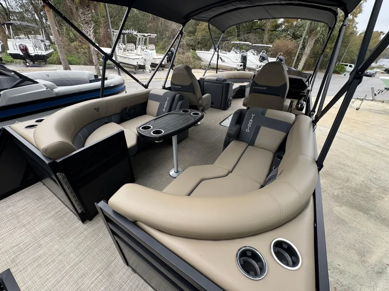Slide: The Image of Viaggio Lago Z-U 2025 pontoon boat interior with beige seating and cup holders. - 8