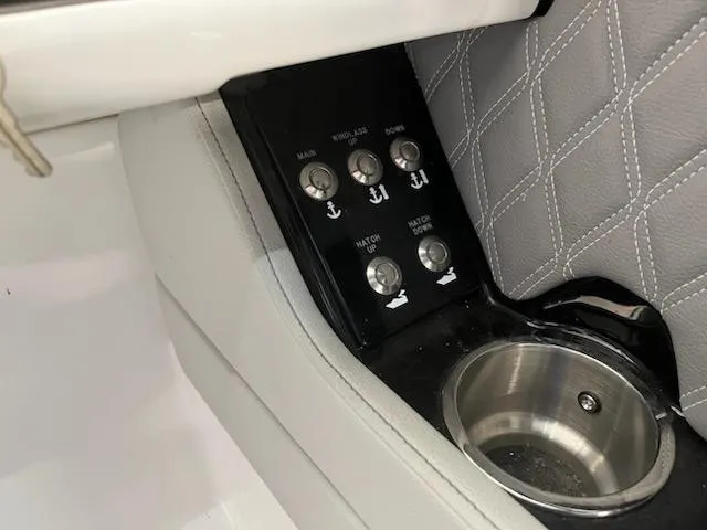 Slide: The Image of Control panel and cup holder on 2021 Sea Ray 250SLX boat interior. - 20