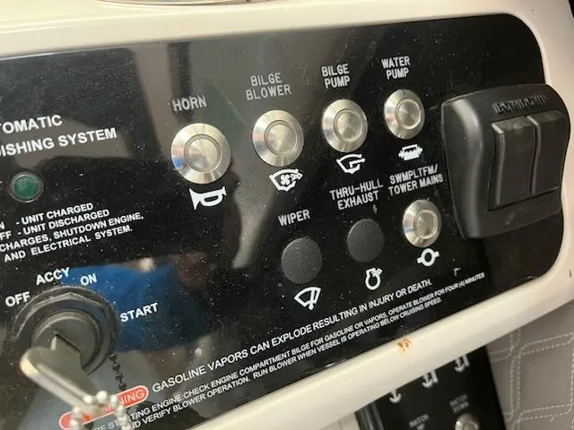 Slide: The Image of Control panel of a 2021 Sea Ray 250SLX boat with various switches and warnings. - 21