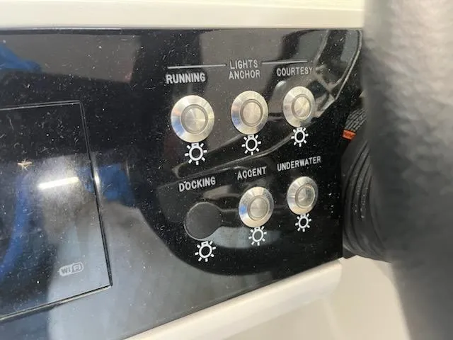 Slide: The Image of Control panel of a 2021 Sea Ray 250SLX boat with various light switches. - 22