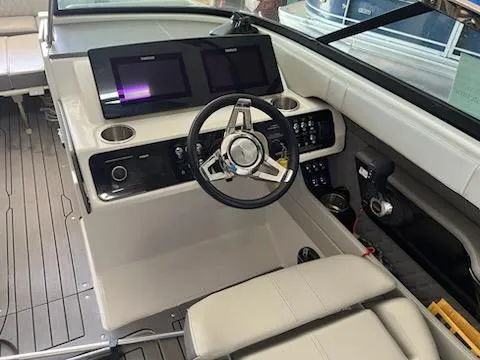 Slide: The Image of 2021 Sea Ray 250SLX boat interior with modern dashboard and steering wheel. - 23