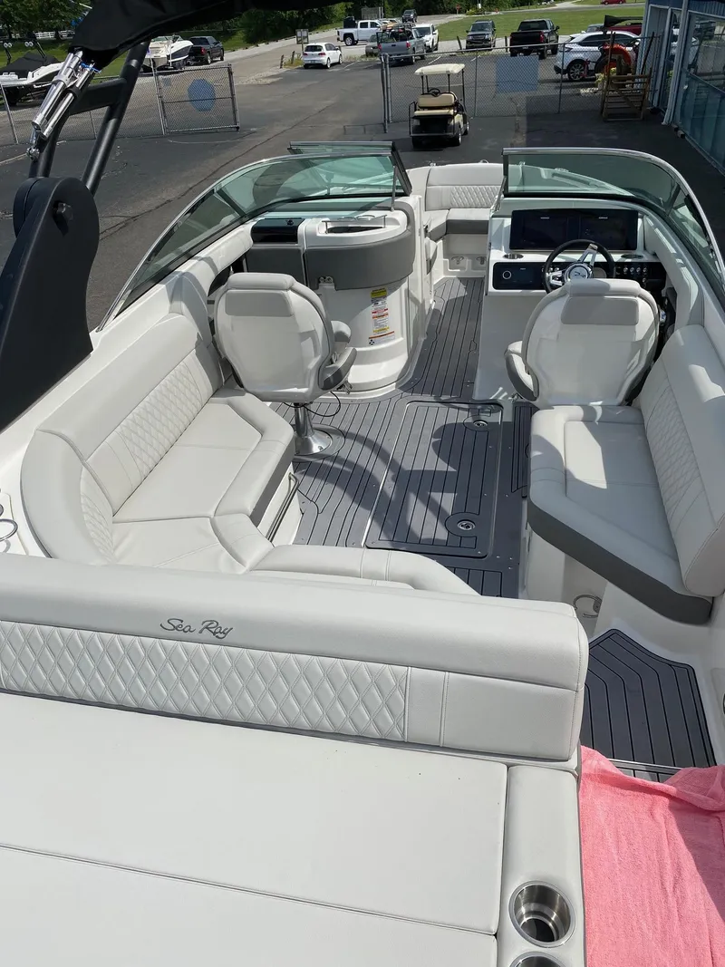 Slide: The Image of 2021 Sea Ray 250SLX boat interior with luxurious seating and modern dashboard. - 4
