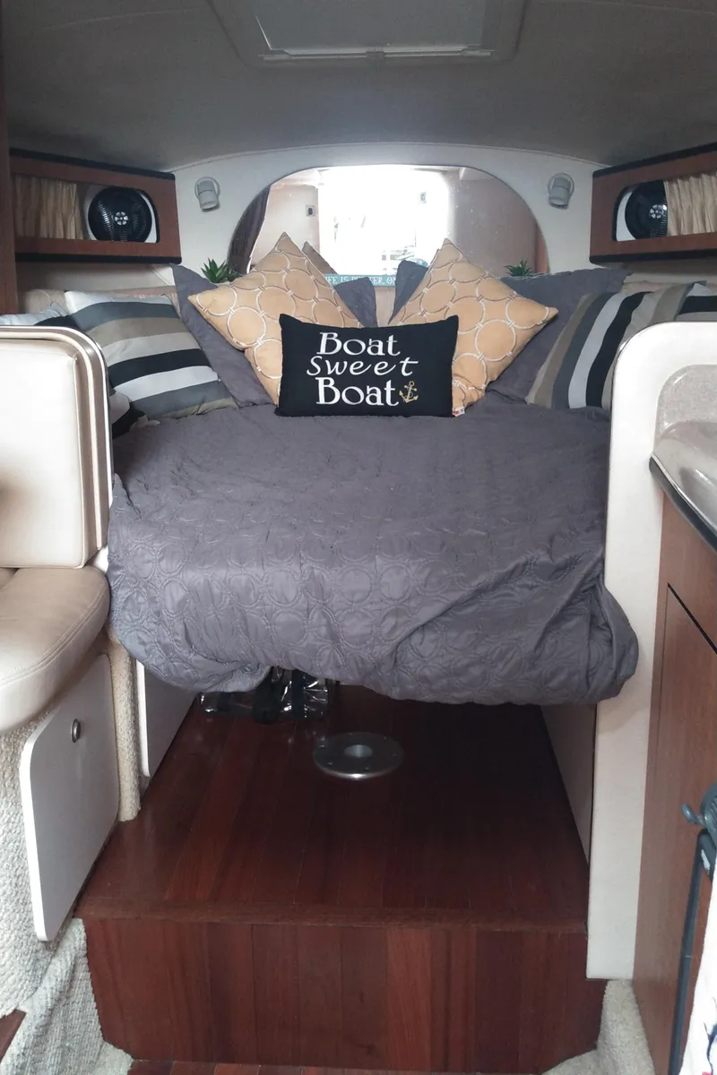 Slide: The Image of Interior of 2006 Sea Ray 280 Sundancer with cozy bed and decorative pillows. - 12