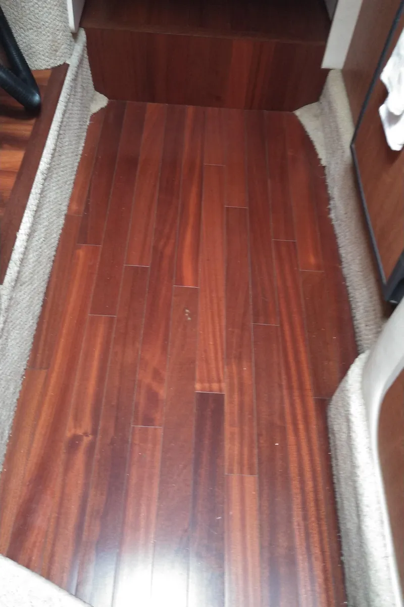 Slide: The Image of 2006 Sea Ray 280 Sundancer interior with polished wooden flooring. - 14