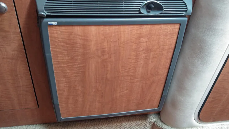 Slide: The Image of Wood-paneled refrigerator in 2006 Sea Ray 280 Sundancer boat interior. - 16