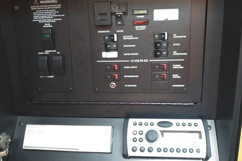 Slide: The Image of Control panel of a 2006 Sea Ray 280 Sundancer boat with various switches and buttons. - 19