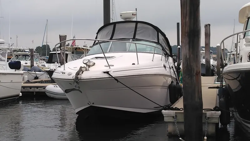 Slide: The Image of 2006 Sea Ray 280 Sundancer docked at marina, front view. - 2