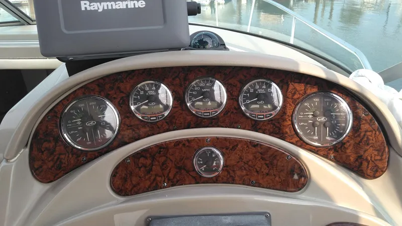 Slide: The Image of Dashboard of 2006 Sea Ray 280 Sundancer with Raymarine navigation system and gauges. - 23