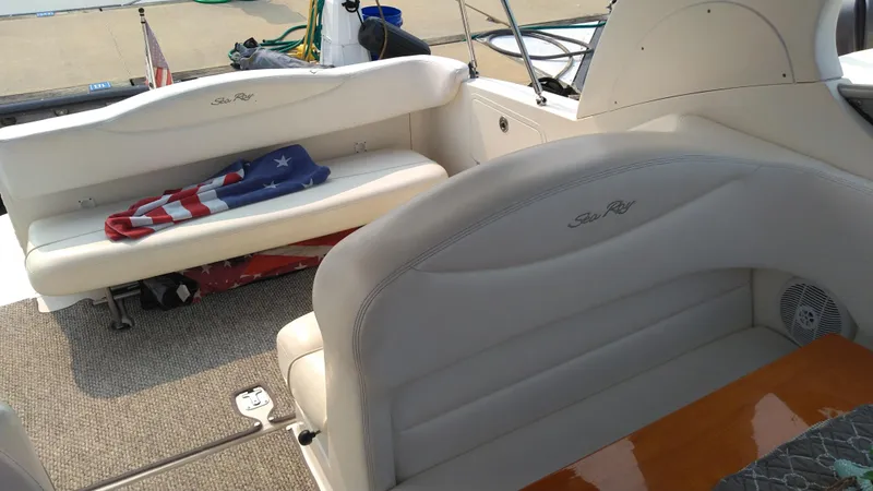Slide: The Image of 2006 Sea Ray 280 Sundancer interior with seating and American flag towel. - 26