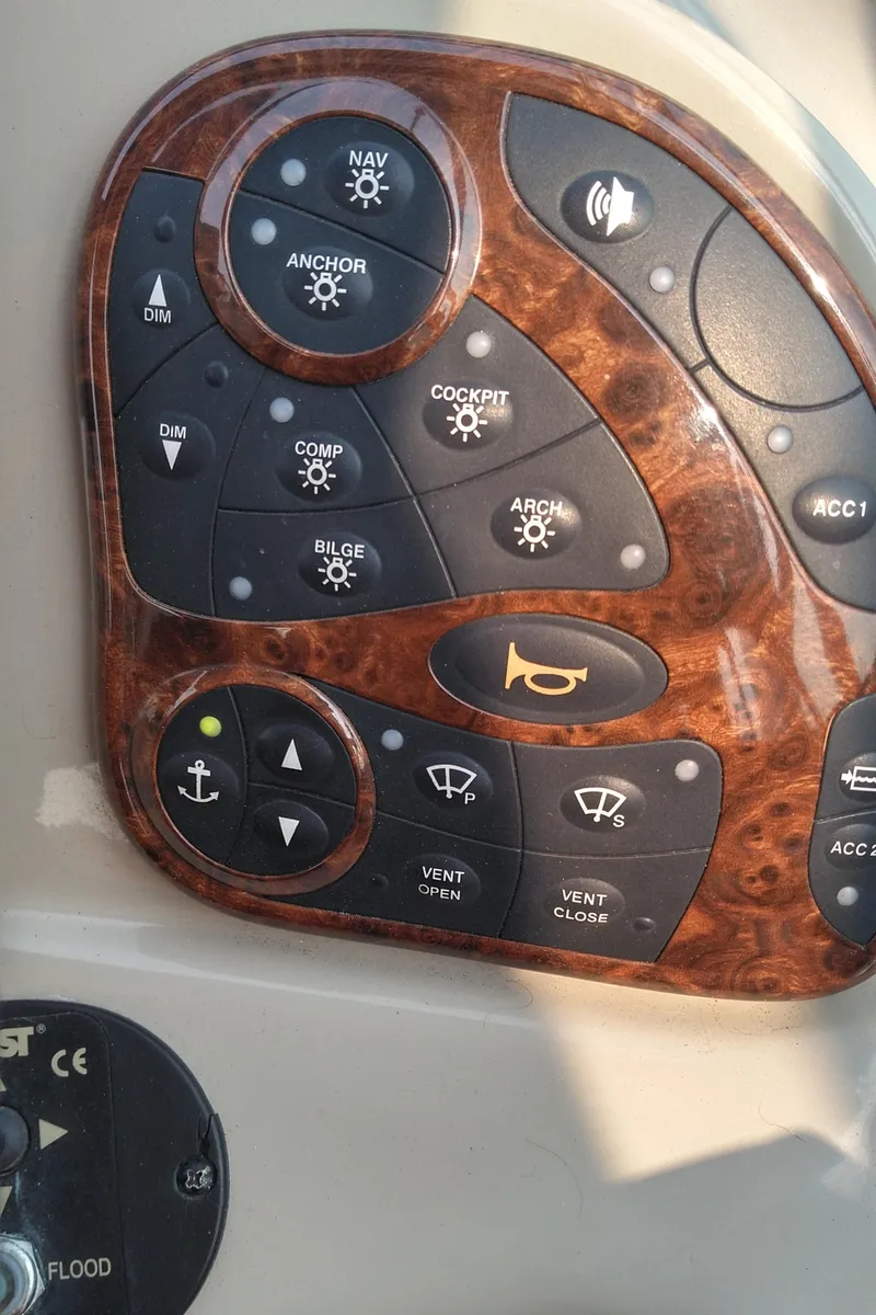 Slide: The Image of Control panel of a 2006 Sea Ray 280 Sundancer boat with various function buttons. - 27