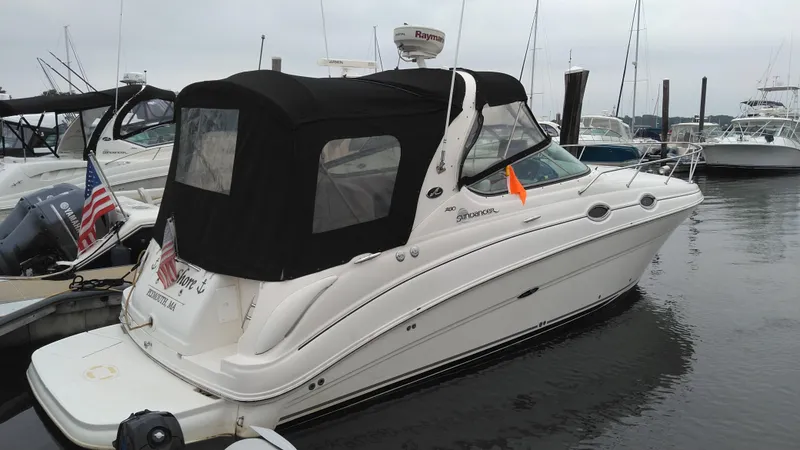 Slide: The Image of 2006 Sea Ray 280 Sundancer boat docked in marina with black canopy. - 3