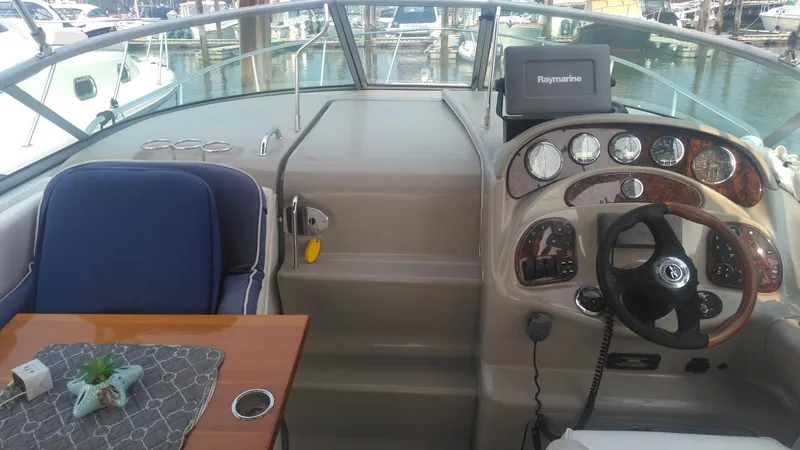 Slide: The Image of 2006 Sea Ray 280 Sundancer cockpit with steering wheel, gauges, and seating area. - 31