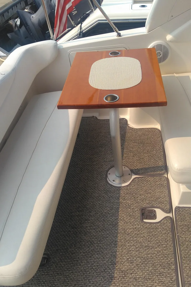 Slide: The Image of 2006 Sea Ray 280 Sundancer interior with wooden table and white seating. - 35