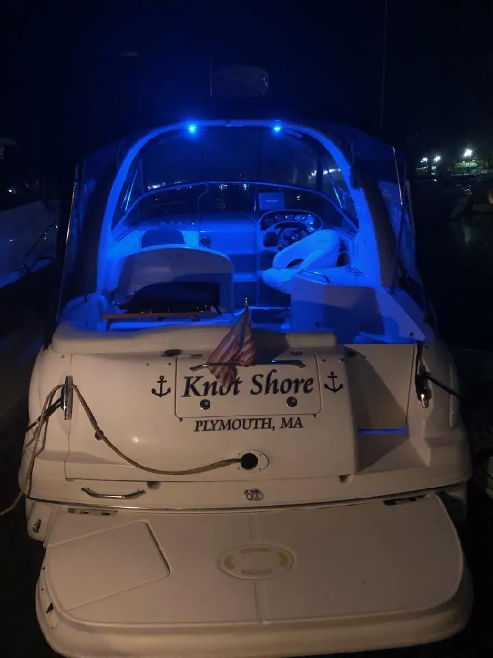 Slide: The Image of 2006 Sea Ray 280 Sundancer boat with blue interior lights, docked at night in Plymouth, MA. - 42