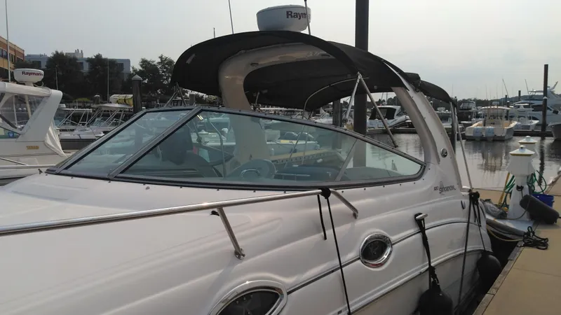 Slide: The Image of 2006 Sea Ray 280 Sundancer docked at marina, featuring sleek design and modern amenities. - 6