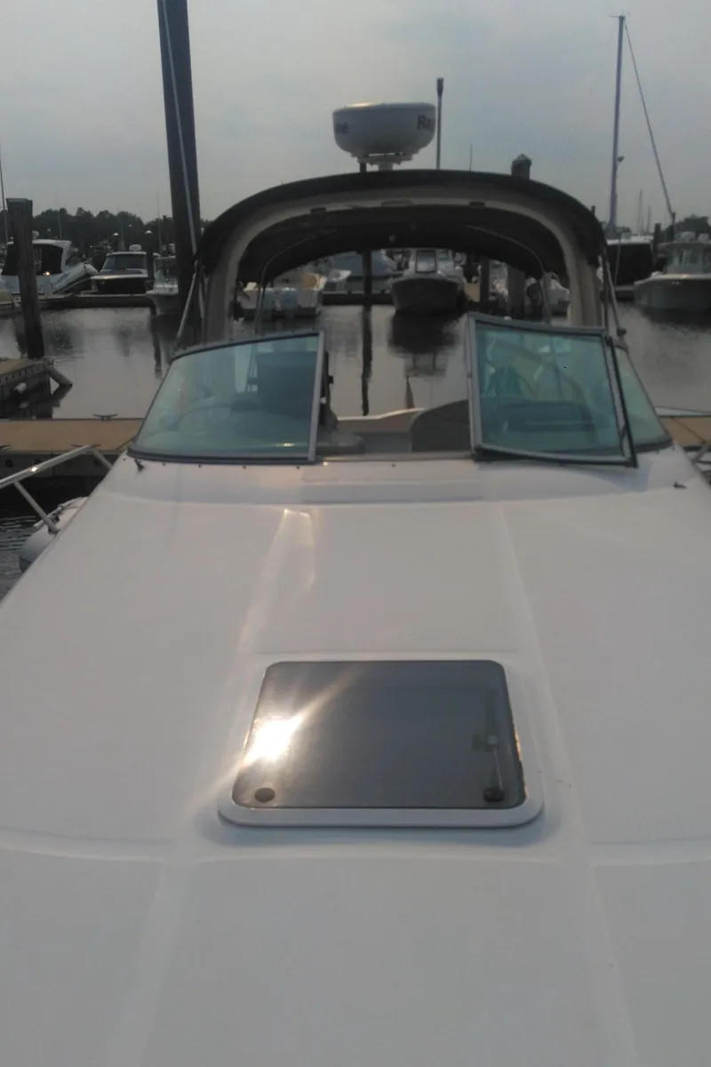 Slide: The Image of 2006 Sea Ray 280 Sundancer docked at marina, front view. - 7