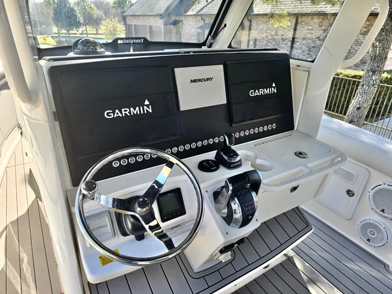 Slide: The Image of 2015 Everglades 355 Tournament boat dashboard with Garmin and Mercury controls. - 12
