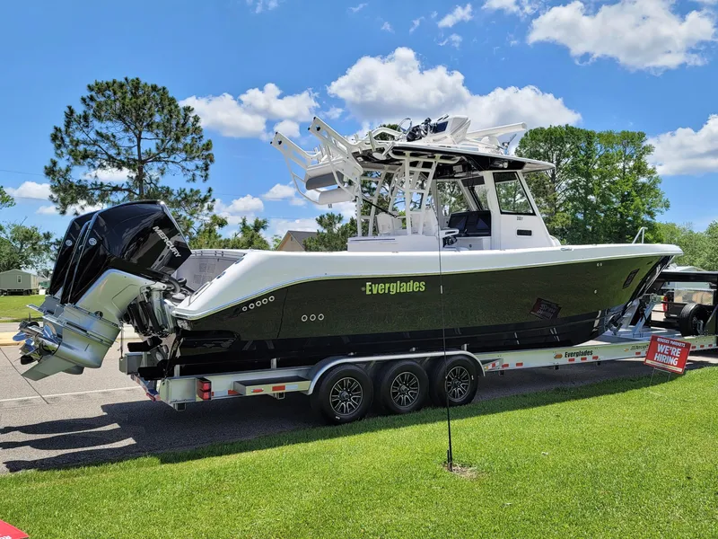 Slide: The Image of 2015 Everglades 355 Tournament boat on trailer, parked on grass under blue sky. - 5