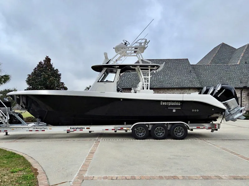 Slide: The Image of 2015 Everglades 355 Tournament boat on trailer, parked outdoors. - 6