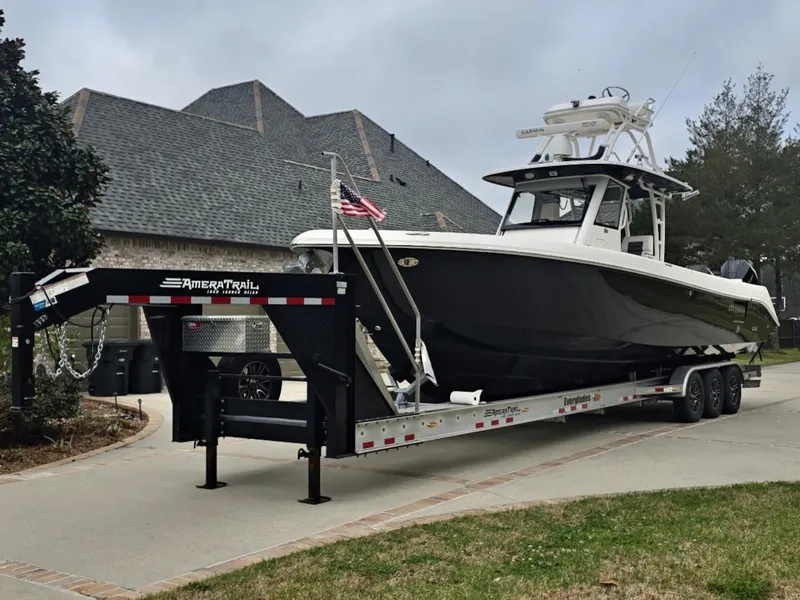 Slide: The Image of 2015 Everglades 355 Tournament boat on trailer in residential driveway. - 9