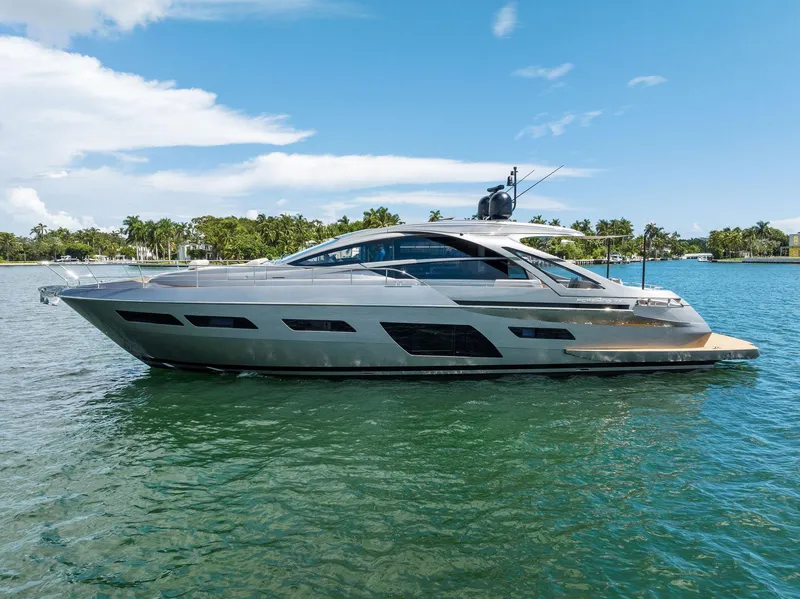 Slide: The Image of 2022 Pershing 7X yacht on serene water with clear blue sky. - 1