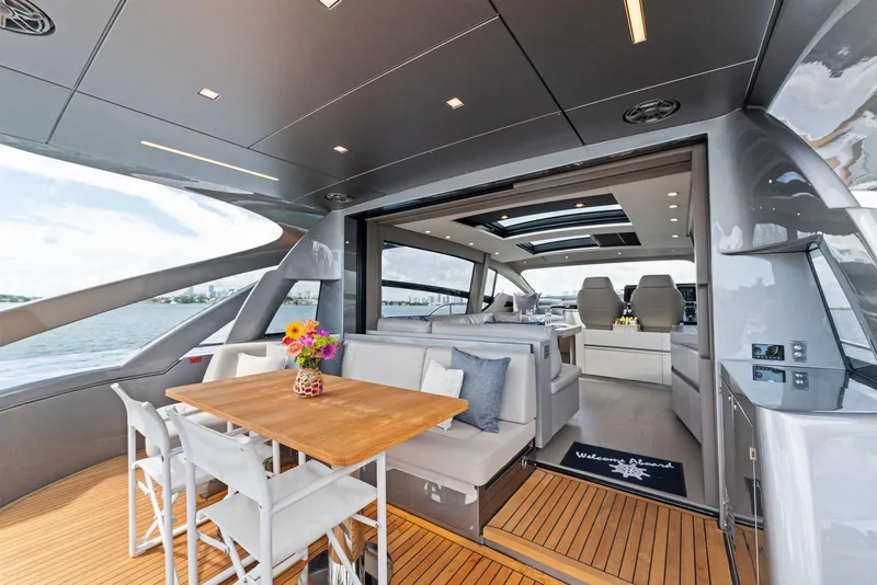 Slide: The Image of Luxurious 2022 Pershing 7X yacht with elegant seating and dining area. - 13