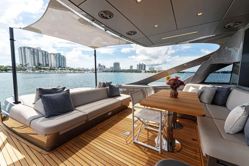 Slide: The Image of Luxurious 2022 Pershing 7X yacht deck with elegant seating and scenic waterfront view. - 14