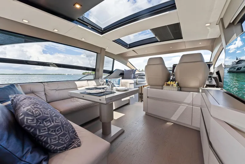 Slide: The Image of Luxurious interior of 2022 Pershing 7X yacht with elegant seating and panoramic windows. - 20