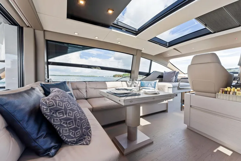 Slide: The Image of Luxurious interior of 2022 Pershing 7X yacht with elegant seating and panoramic windows. - 21