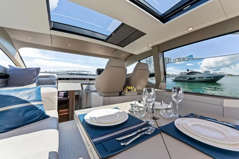 Slide: The Image of Luxurious interior of 2022 Pershing 7X yacht with elegant dining setup and scenic ocean view. - 24