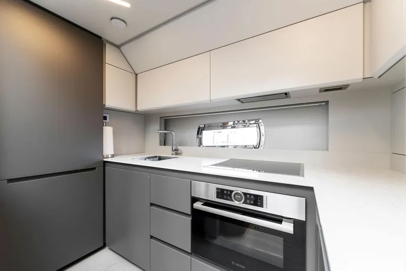 Slide: The Image of Modern kitchen interior in 2022 Pershing 7X yacht, featuring sleek cabinetry and appliances. - 29