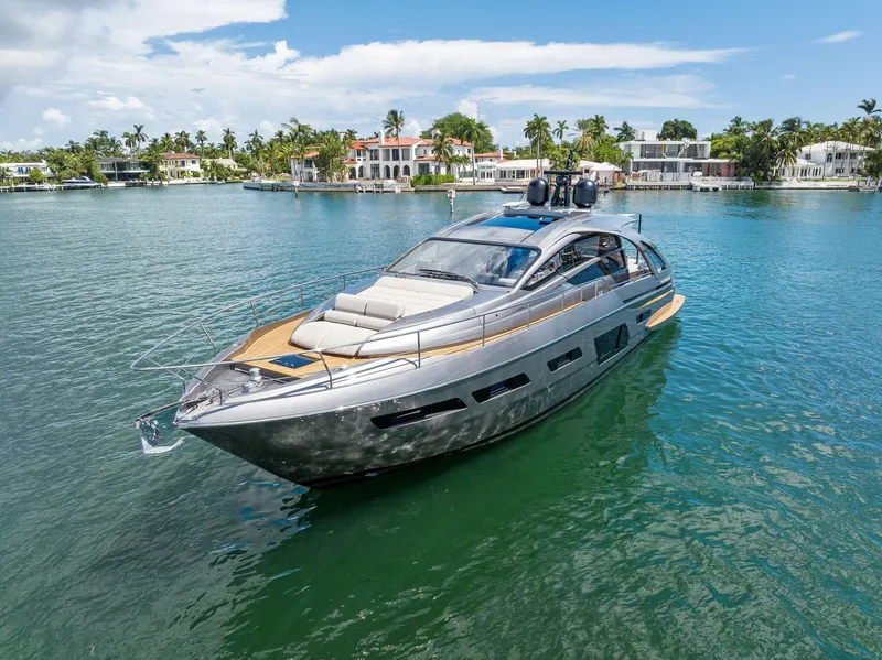 Slide: The Image of 2022 Pershing 7X yacht on serene water with luxury waterfront homes in the background. - 3