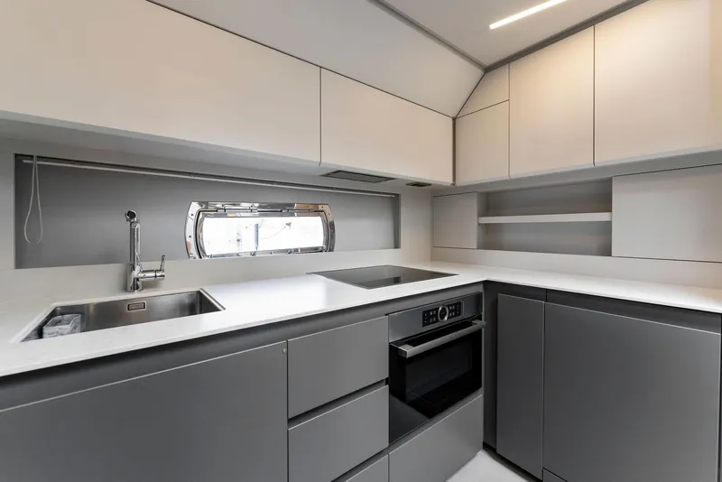 Slide: The Image of Modern kitchen interior in 2022 Pershing 7X yacht, featuring sleek cabinetry and appliances. - 30