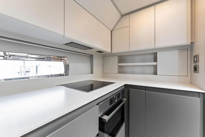 Slide: The Image of Modern kitchen interior in 2022 Pershing 7X yacht, featuring sleek cabinetry and appliances. - 31