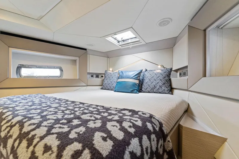 Slide: The Image of Luxurious bedroom interior of 2022 Pershing 7X yacht with modern design and cozy bedding. - 33