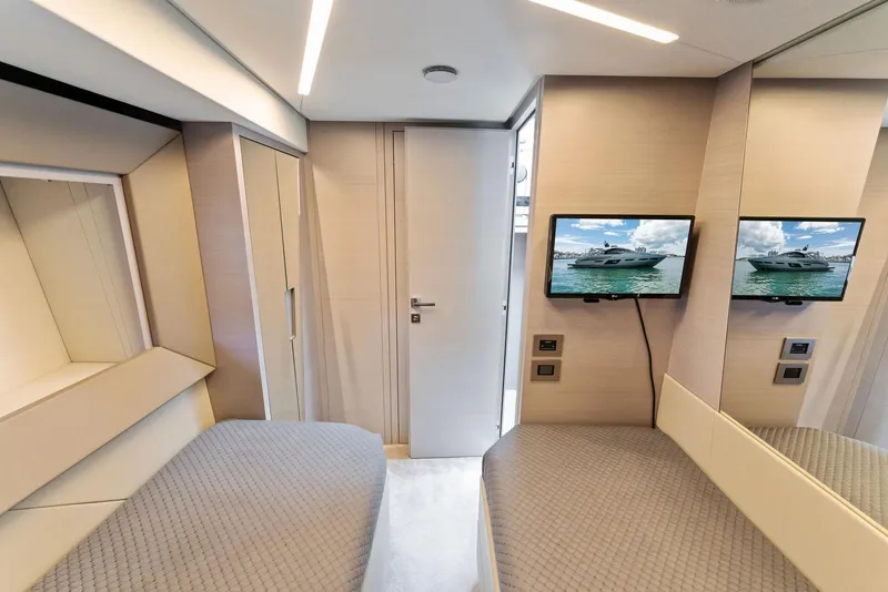Slide: The Image of Luxurious interior of 2022 Pershing 7X yacht with twin beds and wall-mounted TV. - 38