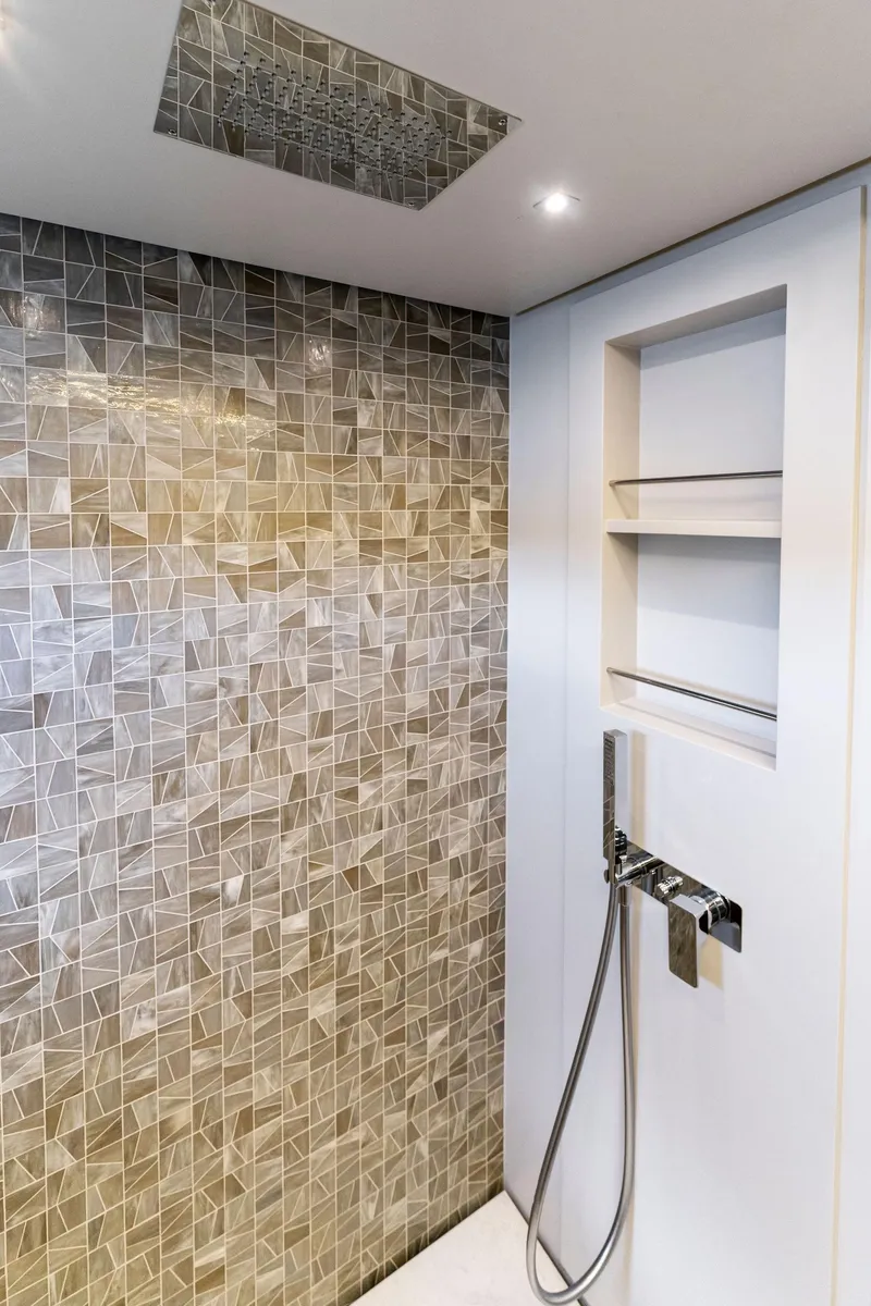 Slide: The Image of Luxurious shower area in 2022 Pershing 7X yacht with modern tile design and sleek fixtures. - 46