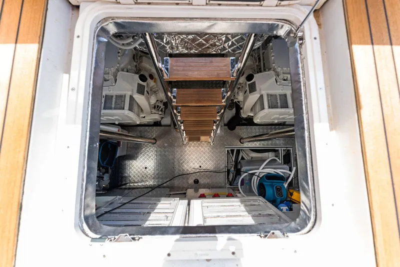 Slide: The Image of Engine room of 2022 Pershing 7X yacht, featuring modern equipment and ladder. - 48