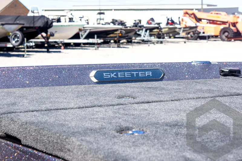 Slide: The Image of 2025 Skeeter FXR 21 Limited boat deck with logo, parked among other boats. - 17