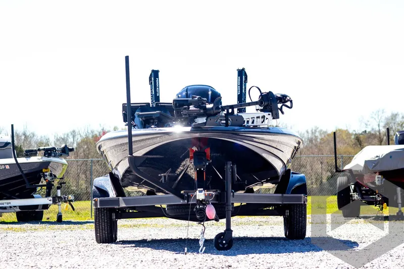 Slide: The Image of 2025 Skeeter FXR 21 Limited boat on trailer, front view, outdoors. - 2