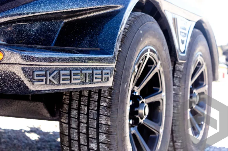 Slide: The Image of 2025 Skeeter FXR 21 Limited trailer with black alloy wheels and logo detail. - 23