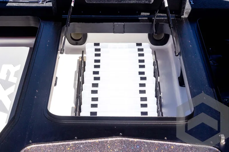 Slide: The Image of 2025 Skeeter FXR 21 Limited boat storage compartment with organized tackle trays. - 29