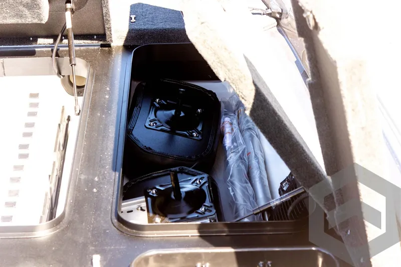 Slide: The Image of Storage compartment of 2025 Skeeter FXR 21 Limited boat, featuring organized equipment. - 30