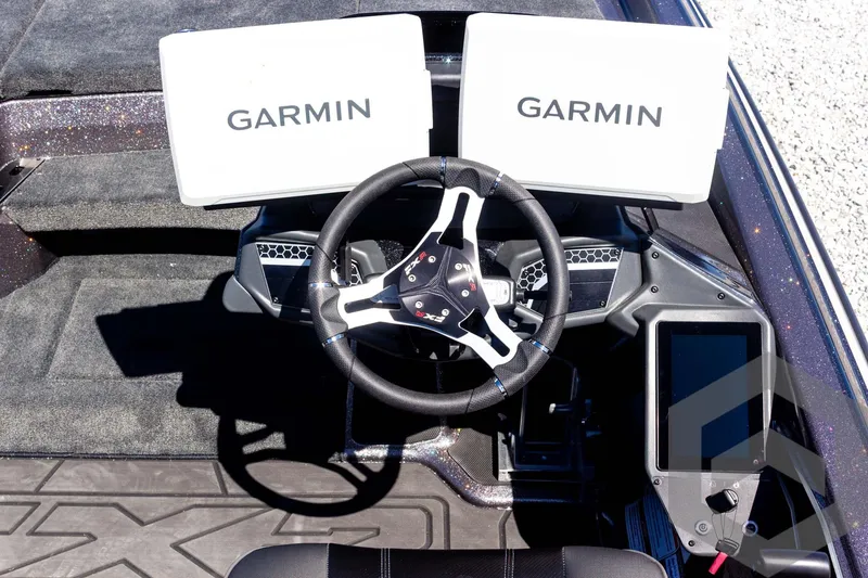 Slide: The Image of 2025 Skeeter FXR 21 Limited dashboard with dual Garmin displays and steering wheel. - 39