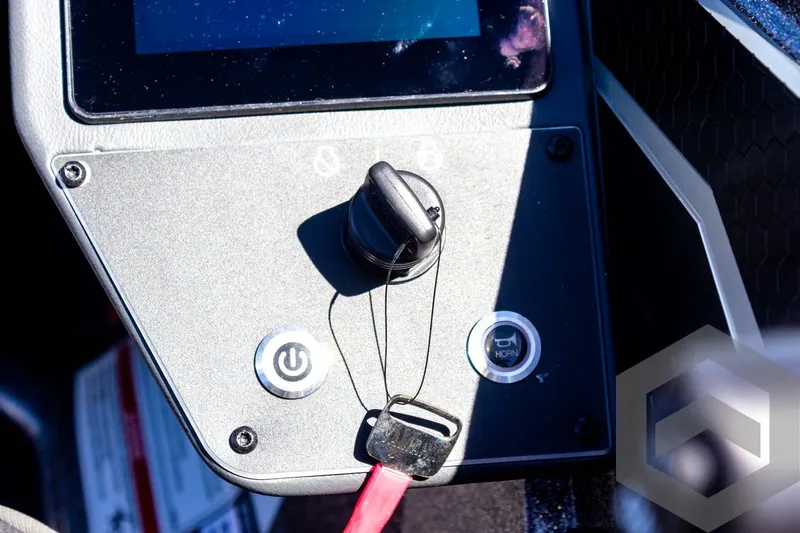 Slide: The Image of Control panel of 2025 Skeeter FXR 21 Limited boat with ignition key and buttons. - 41